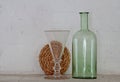Arrangement with clear glass and old green bottle Royalty Free Stock Photo