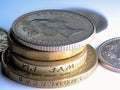 Arrangement of coins in a stack on a white surface