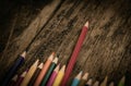 Arrangement of colored pencils on a dark brown wooden table Royalty Free Stock Photo