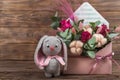 Arrangement in an envelope of flowers in soft pink with cotton, Crochet toy hare. Floral bouquet