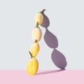 Arrangement of four white eggplant on top of each other. Shadow on pink and gray background