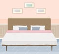 Arrangement of furniture in bedroom. Double wooden bed, sheet, pillow and blanket in interior design Royalty Free Stock Photo