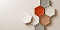 Arrangement of hexagonal ceramic tiles in neutral and warm tones on a smooth beige surface with modern geometric composition Royalty Free Stock Photo