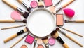 Arrangement of makeup brushes and products around a central circle Royalty Free Stock Photo