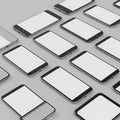 Arrangement of multiple blank screen smartphones displaying white space on a light gray surface Royalty Free Stock Photo