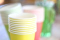 Arrangement of recycling disposable colorful paper cups, glass of red, yellow color