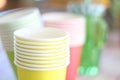 Arrangement of recycling disposable colorful paper cups, glass of red, yellow color