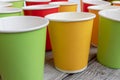 Arrangement of recycling disposable colorful paper cups, glass of red, yellow and green color