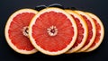 Arrangement of ruby grapefruit slices showcasing fresh texture and vibrant color Royalty Free Stock Photo
