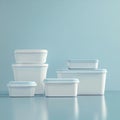 Arrangement of three white plastic containers with blue lids on a blue background Royalty Free Stock Photo