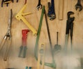 An arrangement of tools on a wooden wall. Closeup of a collection of tools hanging. Neat, tidy mechanics tools and