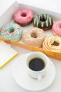 Cup of coffee and box of doughnuts Royalty Free Stock Photo
