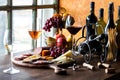 An arrangement of wine and gourmet meats and cheese on a rustic wooden table. Royalty Free Stock Photo