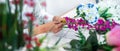 Arranging artificial flowers decoration at home, Young woman florist work making organizing diy artificial flower, craft and hand