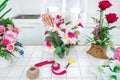 Arranging artificial flowers decoration at home, Young woman florist work making organizing diy artificial flower, craft and hand