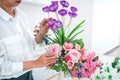 Arranging artificial flowers decoration at home, Young woman florist work making organizing diy artificial flower, craft and hand