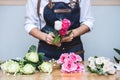 Arranging artificial flowers vest decoration at home, Young woman florist work making organizing diy artificial flower, craft and Royalty Free Stock Photo