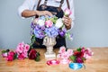 Arranging artificial flowers vest decoration at home, Young woman florist work making organizing diy artificial flower, craft and Royalty Free Stock Photo