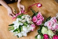 Arranging artificial flowers vest decoration at home, Young woman florist work making organizing diy artificial flower, craft and Royalty Free Stock Photo