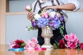 Arranging artificial flowers vest decoration at home, Young woman florist work making organizing diy artificial flower, craft and Royalty Free Stock Photo