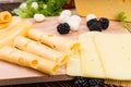 Arranging slices of assorted cheeses on a board