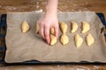 Arranging Unbaked Pastries on Parchment-Lined Baking Tray Before Baking Royalty Free Stock Photo