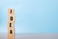 arranging wood cube stacking with idea text on blue background Royalty Free Stock Photo