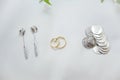 Arras coins for weddings. Silver coins along with other wedding accessories such as gold rings and earrings. Royalty Free Stock Photo