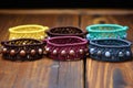 array of adjustable macrame bracelets on dark wood