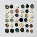 An array of assorted buttons arranged in a grid pattern on a white background. The Royalty Free Stock Photo