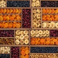 An array of assorted dried fruits neatly organized in wooden compartments. The Royalty Free Stock Photo