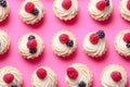 Array of assorted tartlets or cakes with cream cheese, honey, and summer berries. Flat lay, top view of the pastry Royalty Free Stock Photo