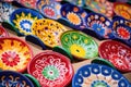 array of brightly painted ceramic plates