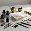 An array of calligraphy tools displayed on a table. There are several ink bottles labele Royalty Free Stock Photo
