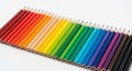 An array of colored pencils is neatly aligned, showcasing a gradient spectrum. Starting with shades Royalty Free Stock Photo
