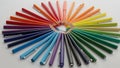 An array of colored pencils is neatly arranged in a radial pattern Royalty Free Stock Photo