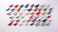 An array of colorful bird wing sculptures arranged in a flight pattern