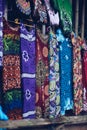 Array of colorful comfortable hand-dyed cotton and silk Batik dress hanging on display