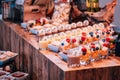 Array of colorful fruit pastries scattered around the wooden table
