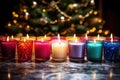 an array of colorful holiday candles on a glass tabletop