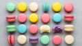 Array of colorful macarons arranged in five neat rows on a gray background Royalty Free Stock Photo