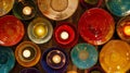 An array of colorful plates and platters are arranged on the table each one adorned with a small candle to enhance its Royalty Free Stock Photo