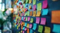 An array of colorful sticky notes affixed to a wall in a creative space Royalty Free Stock Photo