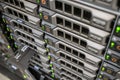 Array of database servers with many hard drives and service tag. Powerful computer equipment works in the server room of the data