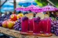 Array of items like grapes, grape juice, and umbrellas displayed on a table Royalty Free Stock Photo