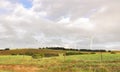 An array of large wind turbines moving to create kinetic energy for renewable energy supply Royalty Free Stock Photo