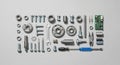 An array of mechanical components and tools arranged neatly on a gray background. The items include Royalty Free Stock Photo