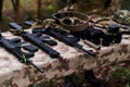 An array of military weapons, including rifles and pistols, is meticulously arranged on a table in a military base Royalty Free Stock Photo