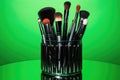 array of professional makeup brushes on neon green backdrop Royalty Free Stock Photo