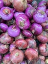Array of purple onions displayed in the market, ready for purchase